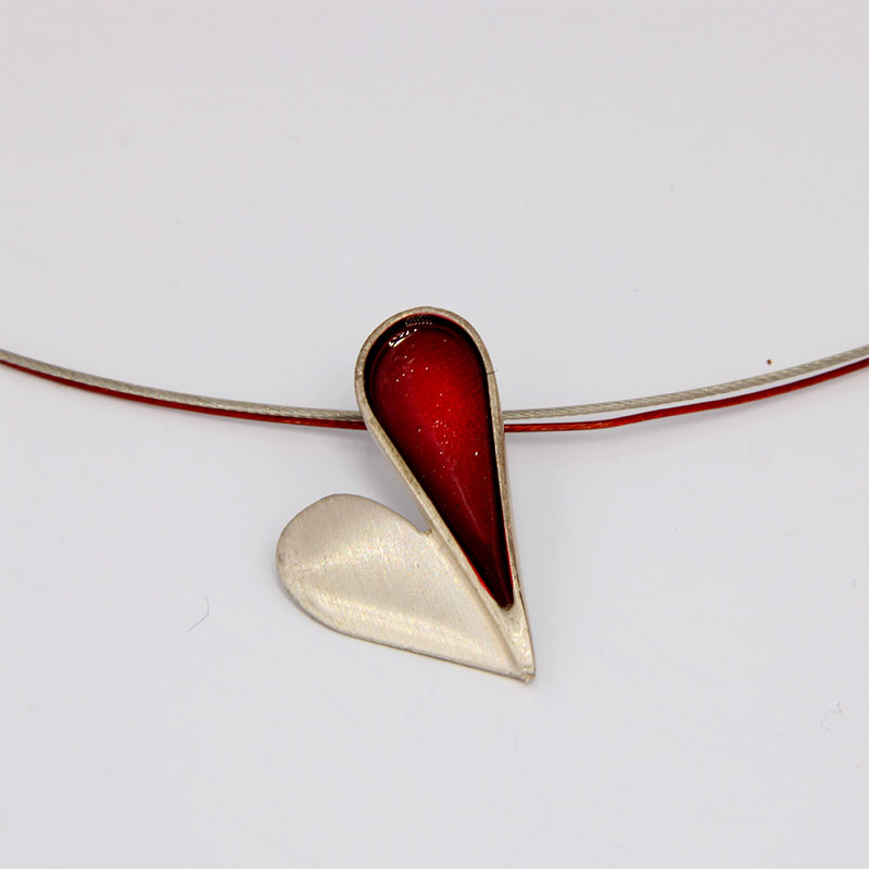 Womens handmade pendant made of 925 ° silver with red enamel detail.