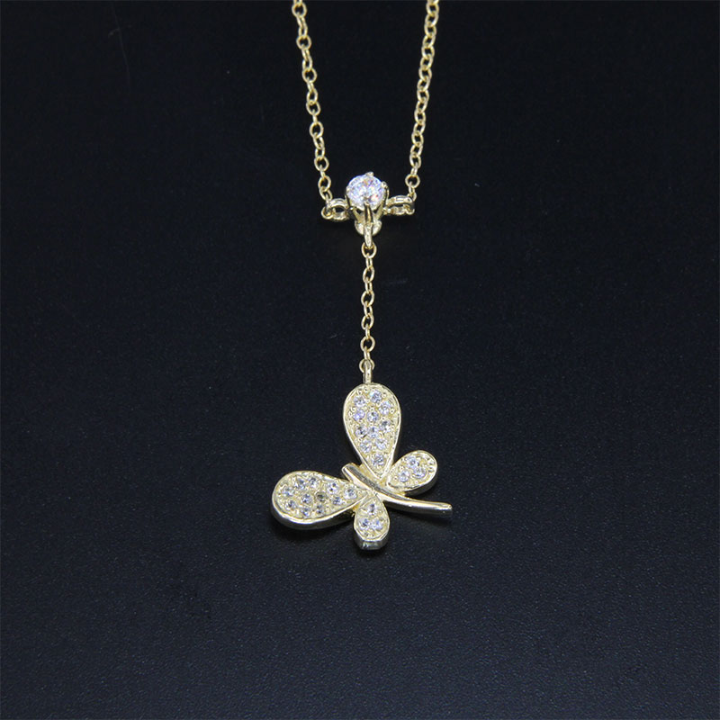 Womens gold pendant with K14 chain in the shape of a butterfly decorated with white zircons.