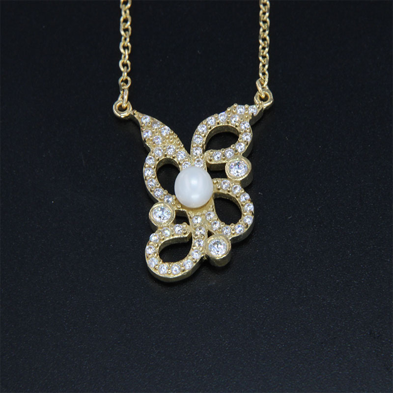 Womens gold pendant with K9 chain decorated with white zircons and natural Pearls.